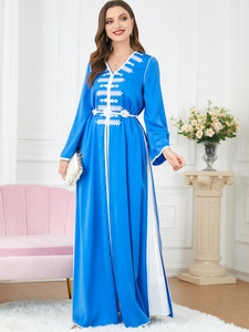 Detailed white floral embroidery and V-neckline on the bright blue satin kaftan dress