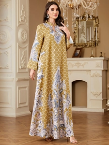 Detail of bohemian yellow kaftan dress with paisley prints and paisley pattern on sleeves