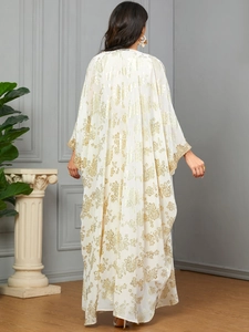 Detailed back view of a white kaftan with gold floral patterns and embroidered cuffs