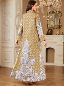 Detail view of ethnic floral paisley patterns on the hem and sleeves of a maxi dress