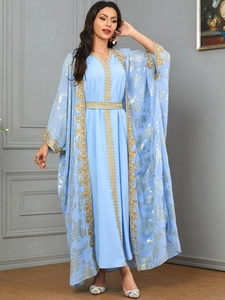 Detail of light blue Middle Eastern dress with gold floral embroidery and matching belt