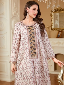 Elegant white Abaya dress with red geometric patterns and gold floral embroidery