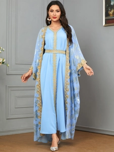 Detail of light blue Kaftan dress with gold floral embroidery and matching belt