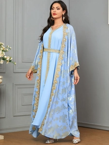 Detail of light blue Kaftan dress with gold embroidery and decorative waist belt