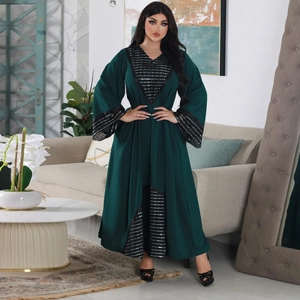 Detailed view of silver sequins and stripes on dark green abaya dress sleeves