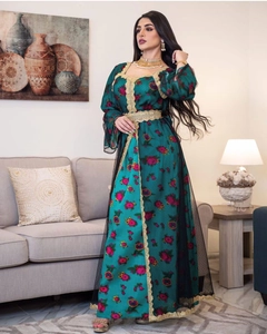 Detail of teal kaftan with golden embroidery, floral print, and ornate metal waist belt