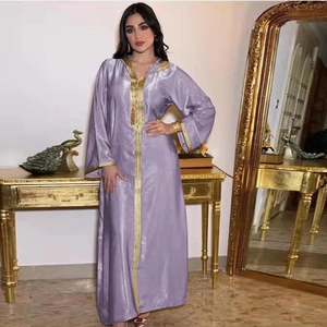 Detailed golden embroidery on the hood and neckline of a purple velvet kaftan dress