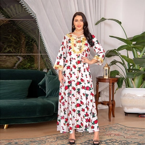 Detailed embroidery on a white floral kaftan dress with long sleeves and ankle-length cut