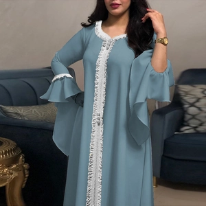 Close-up of grey blue dress featuring white lace embroidery and tiered lotus sleeves