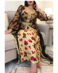 Close-up of golden embroidery lace and rose patterns on black mesh Moroccan Kaftan dress