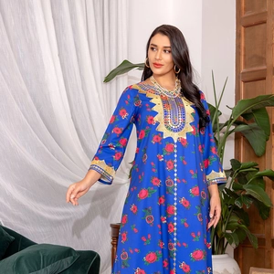 Detail of bohemian royal blue maxi dress with floral prints and gold ethnic embroidery