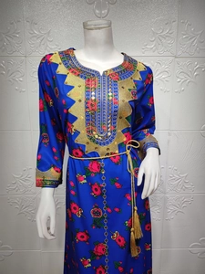 Detail of royal blue ethnic dress featuring gold sequin embroidery and tassel belt