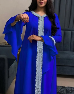 Close-up of royal blue kaftan with silver embroidery and tiered ruffle bell sleeves