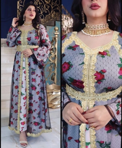 Detailed close-up of ethnic style grey tulle abaya with floral print and gold lace trim
