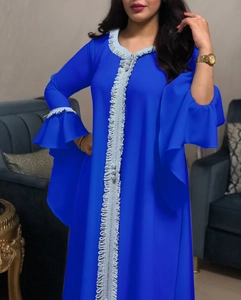 Detail of royal blue dress featuring elegant silver lace embroidery and ruffled bell sleeves