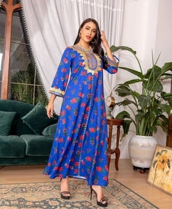 Detailed gold ethnic embroidery and sequins on long-sleeved royal blue floral dress