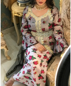 Detailed close-up of ethnic floral embroidery and yellow lace trim on mesh long dress