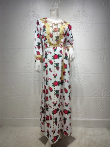 Close-up of golden embroidery and sequins on the ethnic floral maxi dress neckline