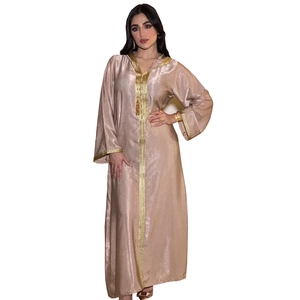 Close-up of champagne satin kaftan showing golden embroidery on hood and cuffs