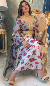 Detailed close-up of intricate gold sequin embroidery on floral ethnic kaftan dress