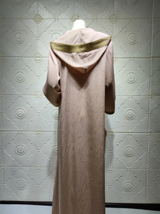Detailed back view of champagne hooded kaftan dress with golden lace trim and satin finish
