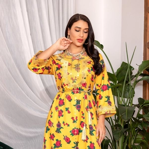 Detailed embroidery with gold sequins on yellow floral dress with tassels
