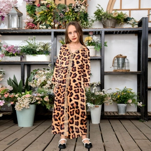 Leopard print girls long sleeve dress with golden lace trim in garden setting