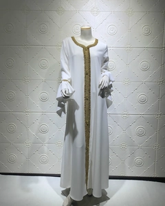 Detail of white long dress with golden sequin embroidery and flared lotus sleeves