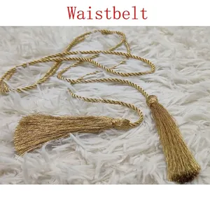 Golden woven rope waist belt featuring intricate braided strands and elegant long tassels