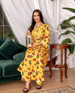 Close-up of yellow floral kaftan dress featuring ethnic embroidery and sequin details