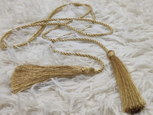Golden woven cord with fringe tassels for curtain tieback or graduation honor rope