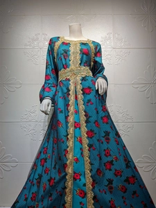 Detail of floral printed maxi dress with golden lace embroidery and mesh fabric texture