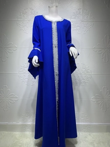 Detailed view of silver floral embroidery and layered ruffle sleeves on blue dress