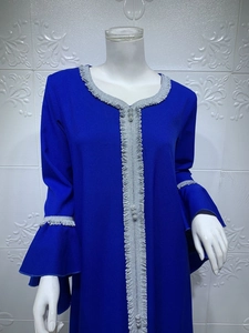 Close-up of royal blue kaftan with silver wavy trim and ruffled bell sleeves detail