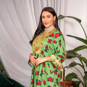 Detail of green floral kaftan dress featuring intricate gold embroidery on cuffs and neckline