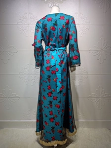 Detail view of ethnic floral dress back with trumpet sleeves and mesh lace hem