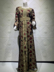 Detail of gold embroidery and rose print on an ethnic kaftan maxi dress with mesh