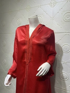 Detailed view of red champagne hooded kaftan dress with satin embroidery and buttons