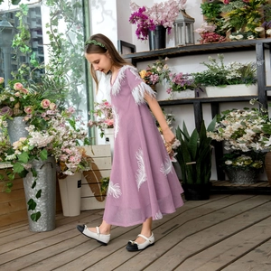 Detail of lavender tulle dress with white feather embroidery and tassel trim for girls