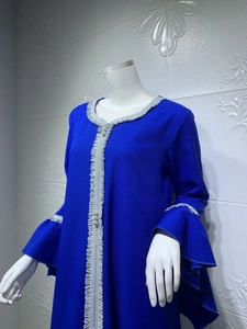 Detail view of navy blue abaya dress with silver pleated lace trim and flared sleeves
