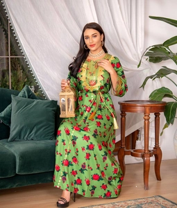 Detailed embroidery and sequins on green kaftan dress with golden tassel belt