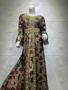 Detail of floral print maxi dress with golden embroidery and black mesh overlay