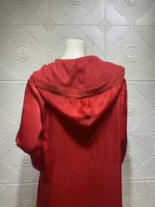 Detailed back view of a champagne red hooded velvet dress with intricate lace trim borders