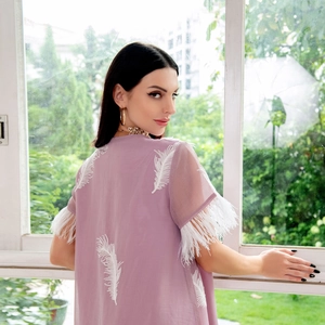 Detail of lavender v-neck dress featuring white feather embroidery and fringe sleeves