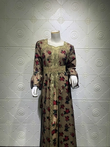 Close-up of ethnic style brown floral maxi dress with intricate golden lace embroidery