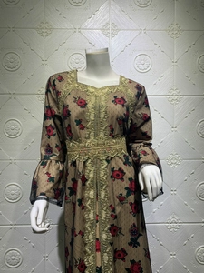 Detail of floral printed mesh kaftan dress with golden lace embroidery on neckline