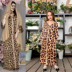Detail view of leopard print mother and daughter maxi dresses with elegant lace embroidery