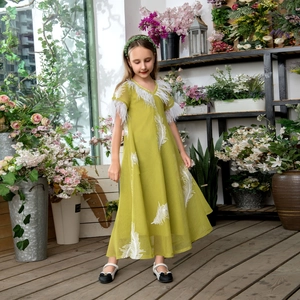 Detail of V-neck kid dress featuring white feather trim and elegant embroidery
