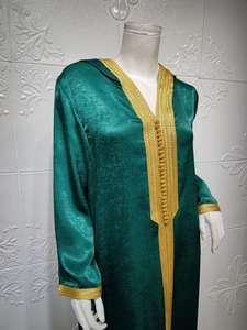 Detail of dark green Moroccan Kaftan with intricate gold braided Sfifa and handmade buttons