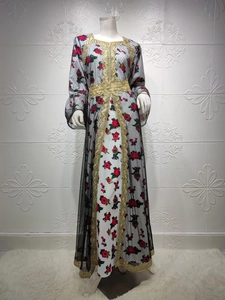 Detail of floral long dress with black mesh overlay and intricate gold lace embroidery